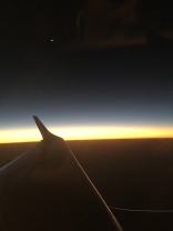 Crescent moon off the wing at sunset